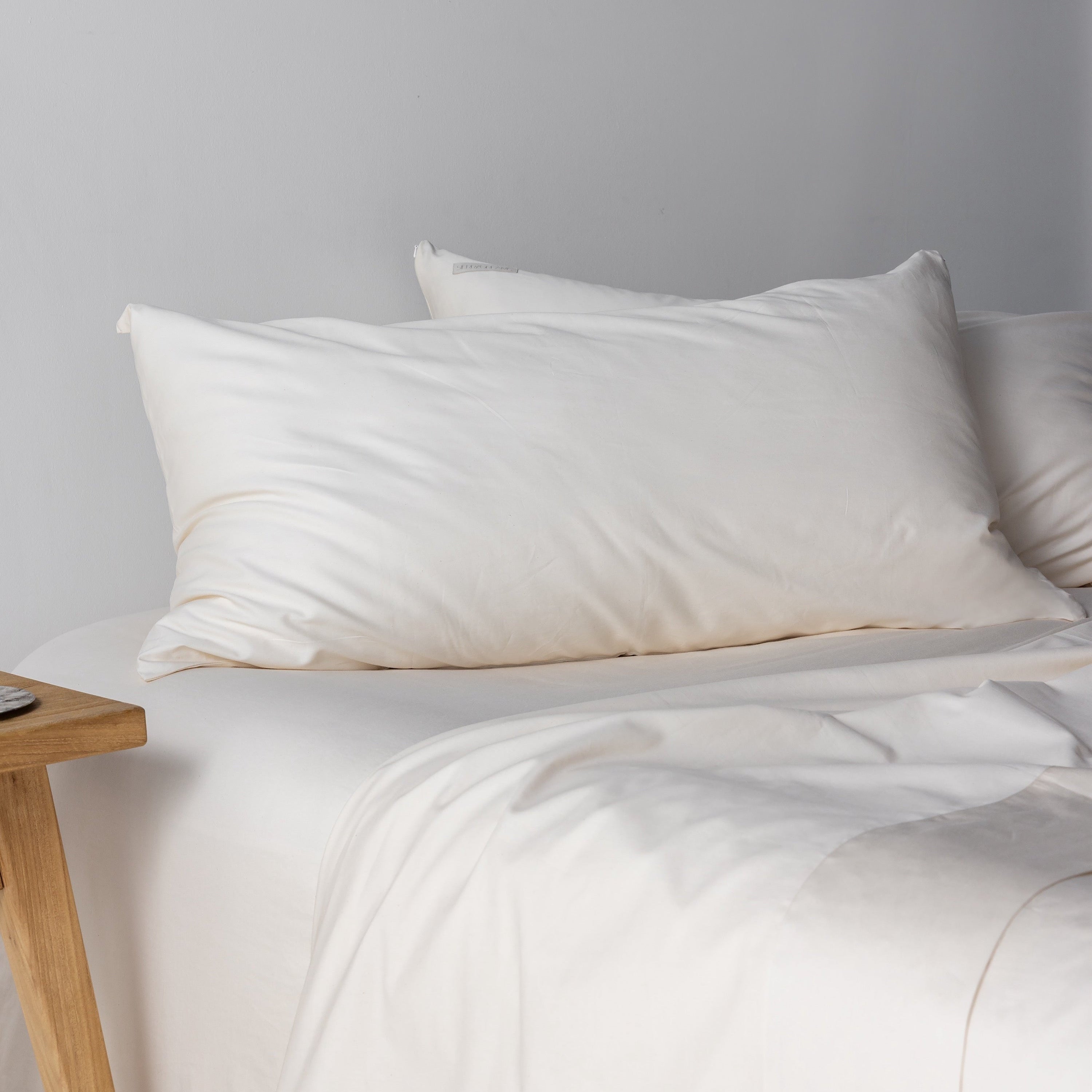 Sierra Dreams organic sateen sheet set in Natural, made on a bed